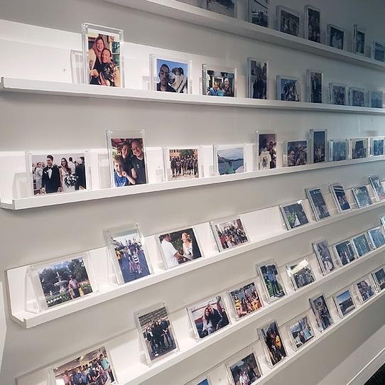 A wall with photos of important moments in the lives of employees